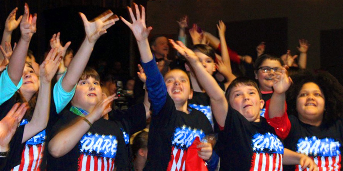 Kids at a Dare Event with Hands in the Air